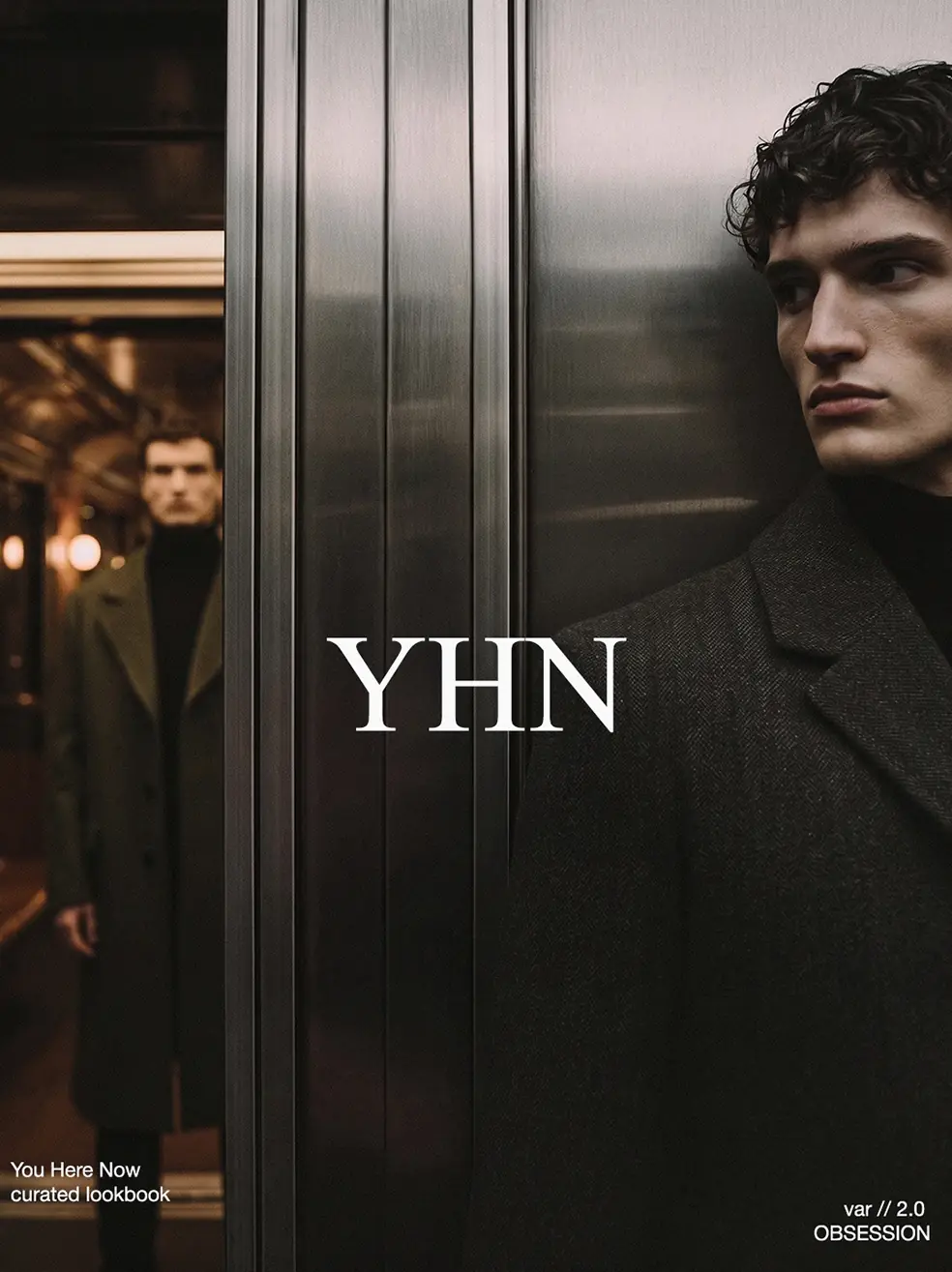 SS26 lookbook, Obsession: two men in dark coats inside a lift with metal doors, with YHN lettering